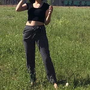 Black crop top and white and black striped pants